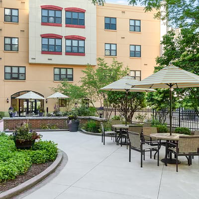 Outdoor seating area with umbrellas and landscaping