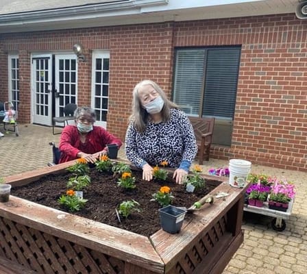 Residents gardening in an outdoor planter box