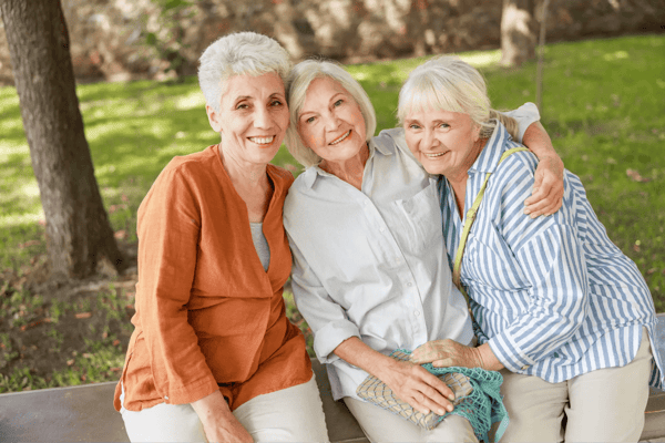 Three smiling senior women enjoying time outdoors