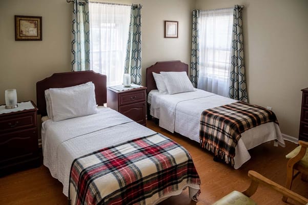Cozy resident room with two beds and natural light