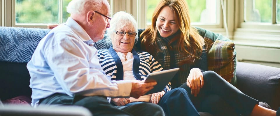 Residents engaging with family in a cozy lounge