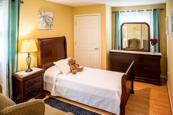 Cozy private resident room with a bed and teddy bear