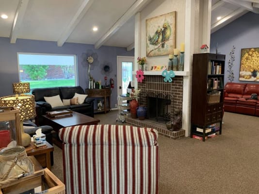 A cozy living room with comfortable seating and a fireplace.