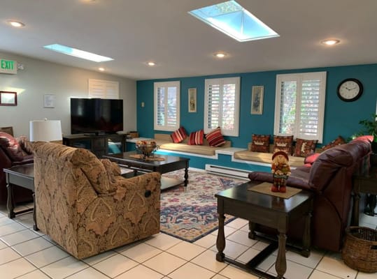 Cozy living room with brown sofas, a coffee table, and blue accent wall