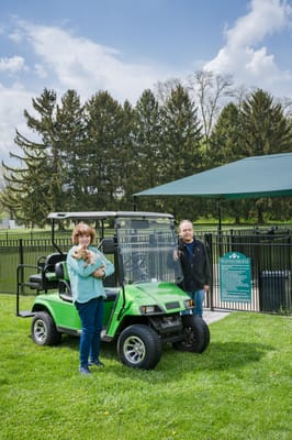 Residents enjoying an outdoor space with a golf cart