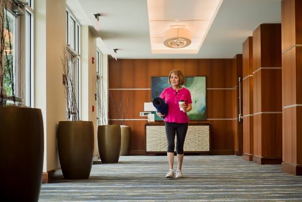 Resident walking in a bright facility hallway