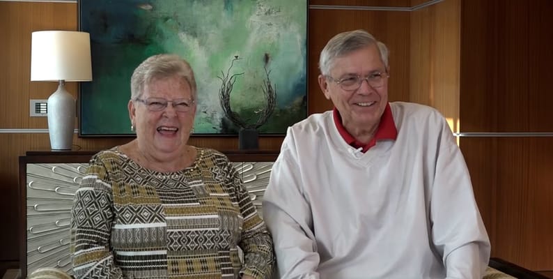 Two smiling residents in a well-lit common area