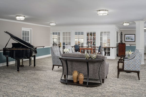Bright common area with a piano and seating