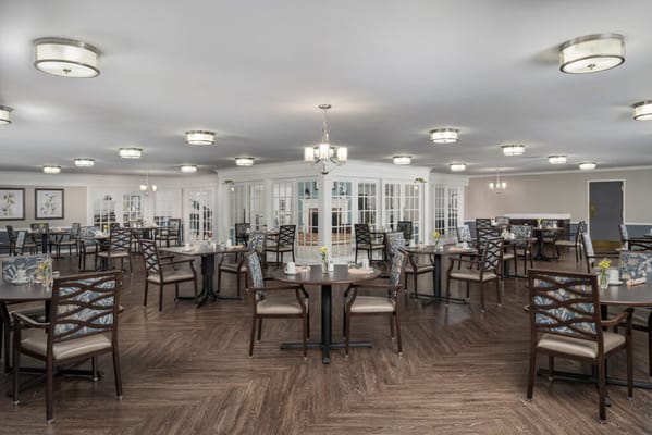 Bright dining room with tables set for meals