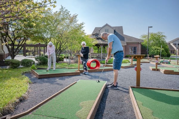 Residents enjoying mini-golf in an outdoor space