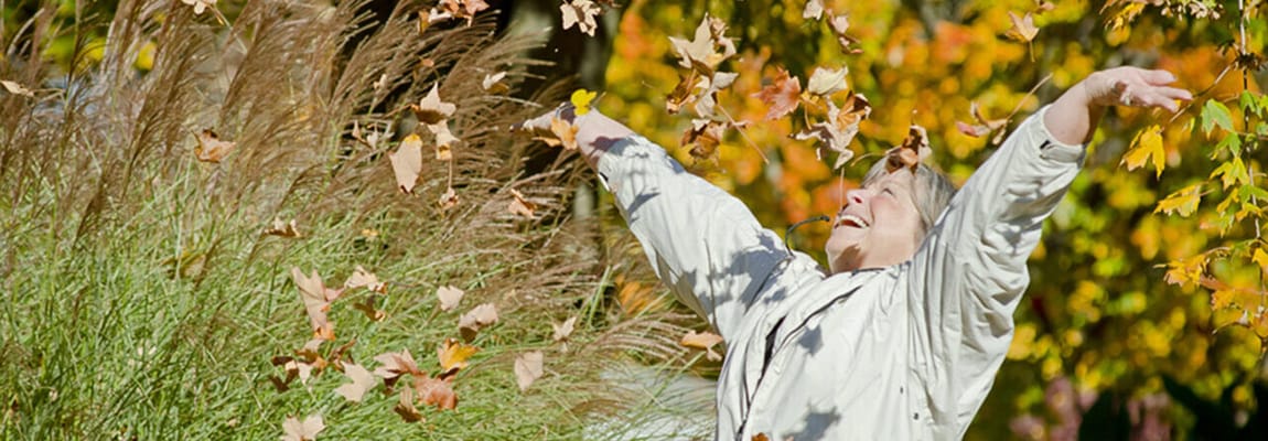 Resident enjoying a fall day with leaves