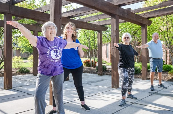 Residents and staff participating in an outdoor exercise class