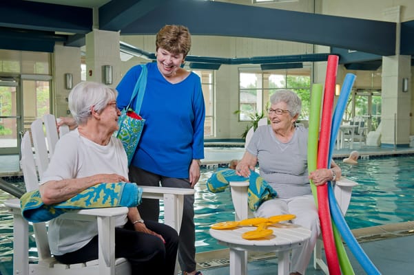 Residents enjoying activity around the indoor pool