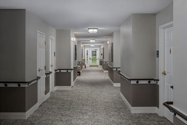 A hallway in the assisted living facility with doors and windows
