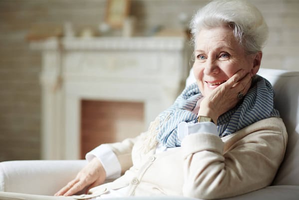 Senior woman smiling in a cozy indoor setting