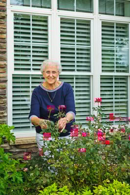 Resident tending to flowers in a garden