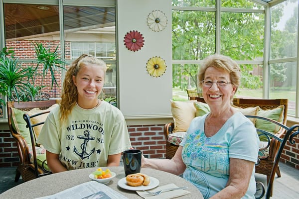 Resident and visitor enjoying coffee and snacks together