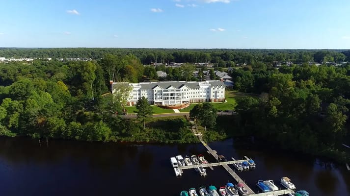 Aerial view of Auburn Hill Senior Living by a lake