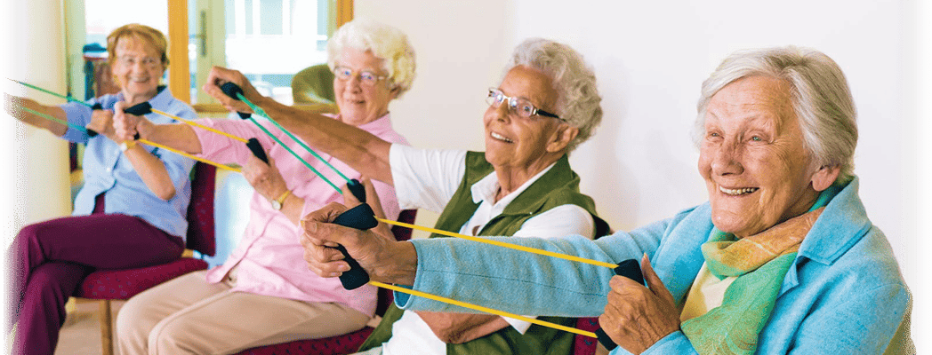 Seniors participating in a group exercise activity with resistance bands