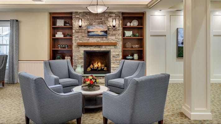 Cozy common area with a stone fireplace and seating