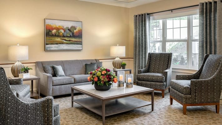 Bright lobby area with comfortable seating and floral arrangements