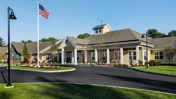 Exterior view of the Bridges at Sudbury facility with flowers
