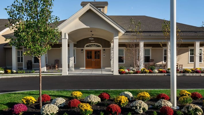 Exterior view of a senior living facility with flowers