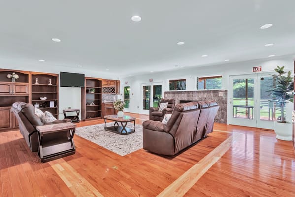 Bright common area with comfortable seating and windows