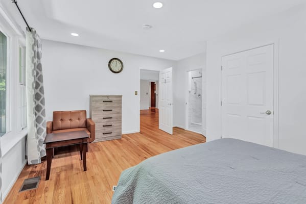 Cozy private room with wooden floors and natural light