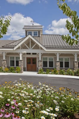 Exterior view of a senior living facility with flowers