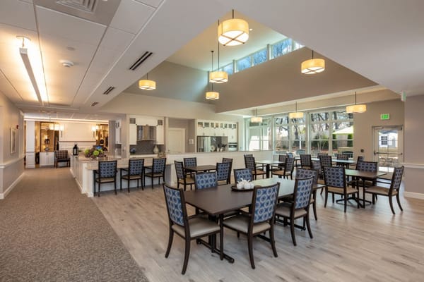 Bright and spacious dining room with tables and chairs