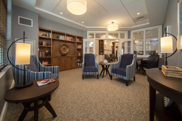 Cozy common area with comfortable seating and bookshelves