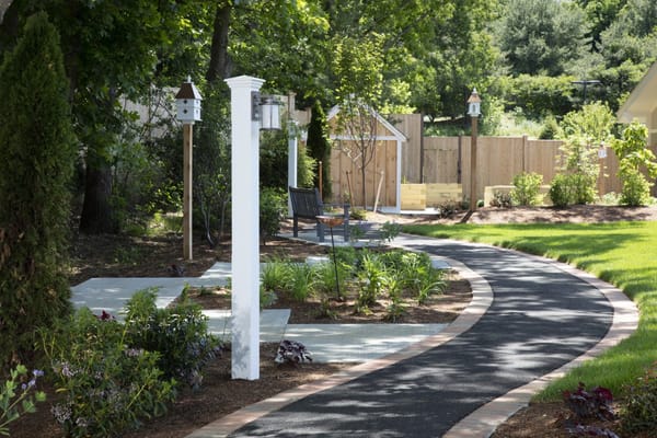 Pathway in a landscaped garden with seating
