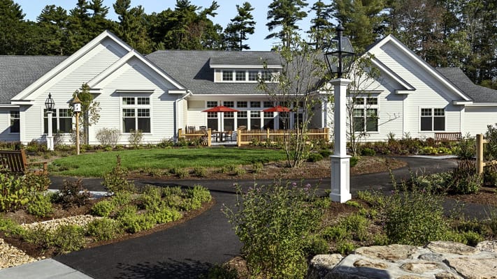 Exterior view of a senior living facility with gardens