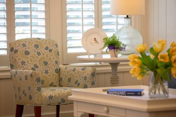 Cozy interior seating area with floral chair and table