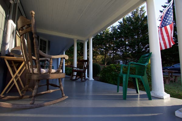 Porch area with rocking chairs and American flag