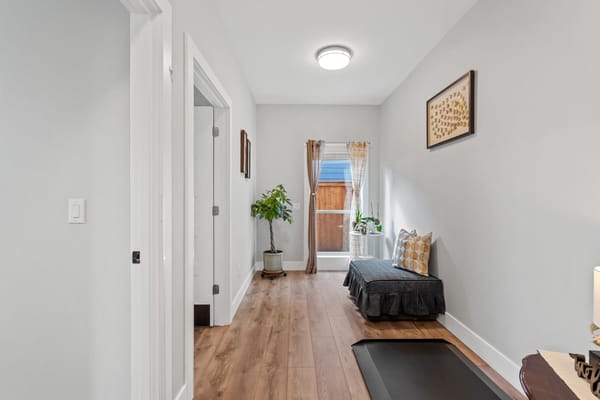 Bright interior hallway with seating area and plants