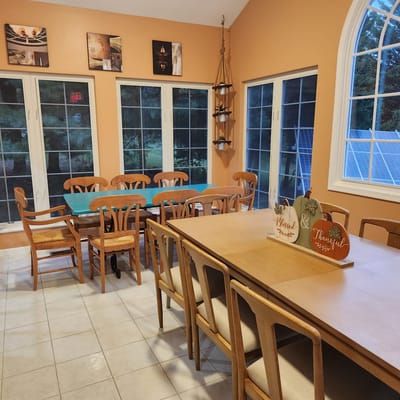 Bright dining area with large windows and tables