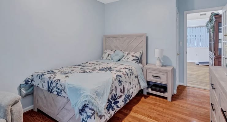 Private resident room with a bed and light decor