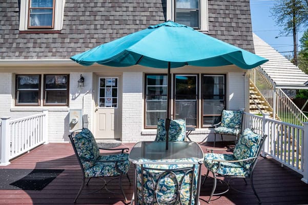 Outdoor seating area with umbrella and chairs