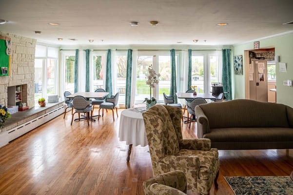 Bright common area with cozy seating and outdoor view