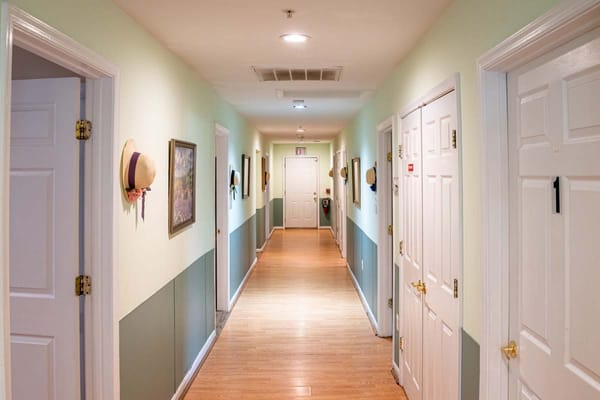 Well-lit hallway of a senior living facility.