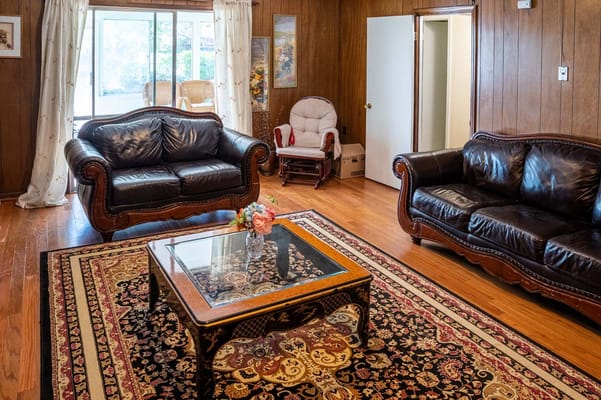 Cozy common area with leather sofas and a coffee table