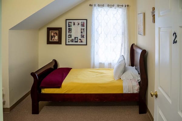 Cozy resident room with a bed and window.