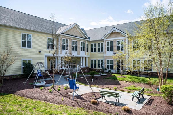 Outdoor courtyard with swings and benches