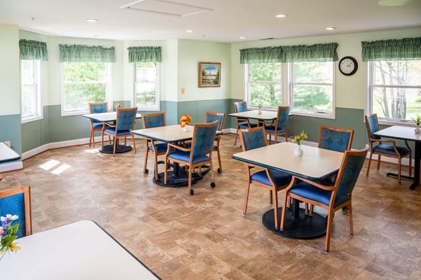 Bright dining area with tables and chairs set up