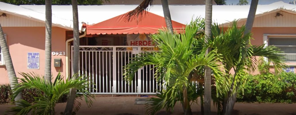 Front view of Angeles ALF Inc. with red canopy and palm trees