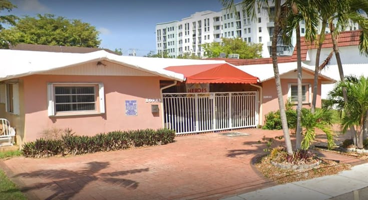Front view of Angeles ALF facility with a red awning.