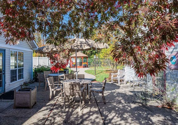 Outdoor patio area with tables and umbrellas