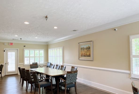 Bright dining area with a large table and chairs